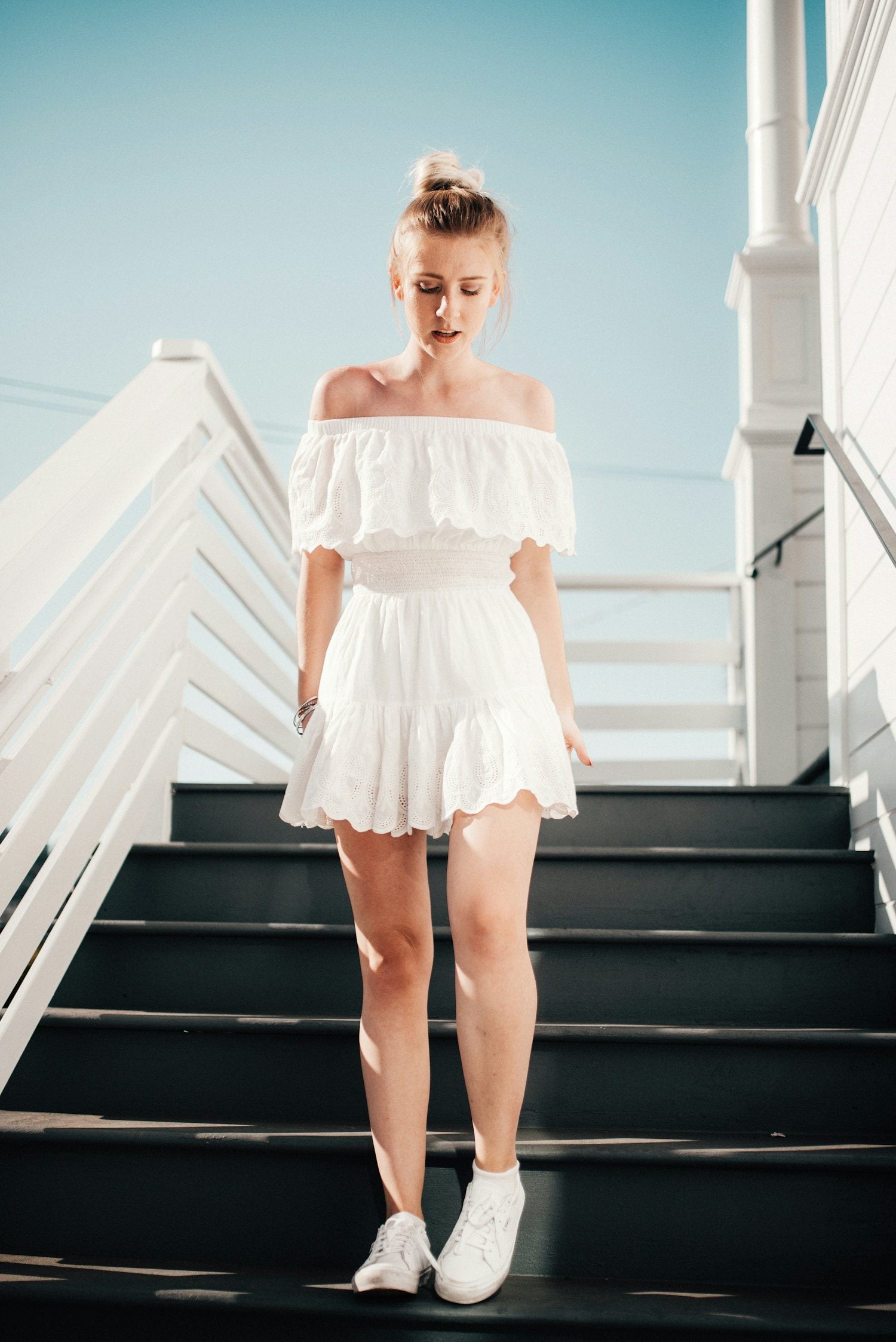 Woman in a white broderie summer dress